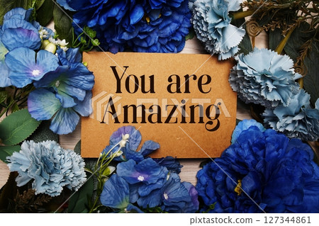 You are Amazing text with blue flowers bouquet decoration on wooden background 127344861