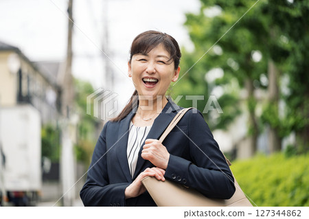 A career woman in her 50s going to work in a suit A career woman in her 50s going to work in a suit 127344862