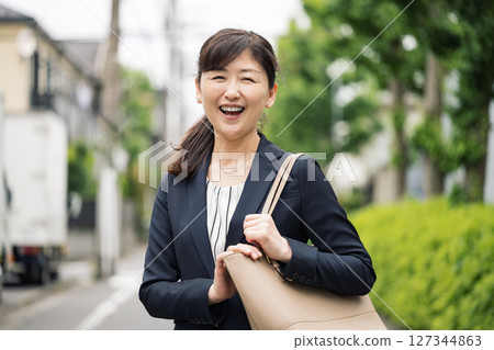 A woman in her 50s going to work in a suit A woman in her 50s going to work in a suit 127344863
