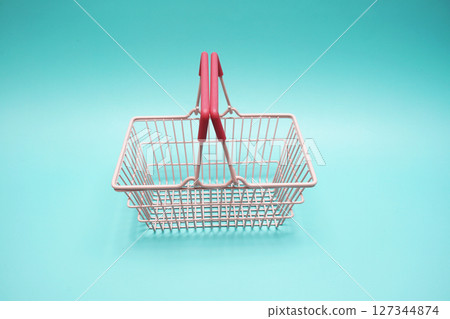 Pink empty shopping basket with space copy on blue background Pink empty shopping basket with space copy on blue background 127344874