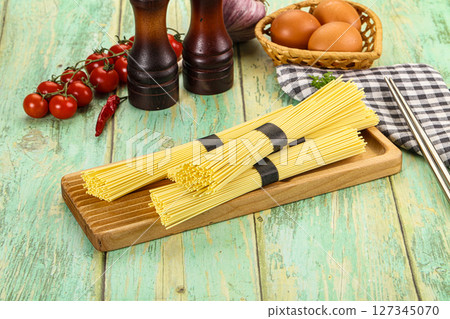 Raw dry uncooked egg noodles Raw dry uncooked egg noodles 127345070