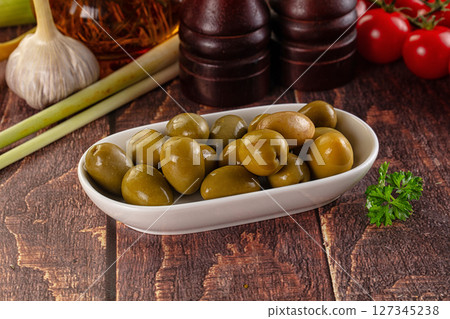 Greek green olives marinated in the bowl 127345238