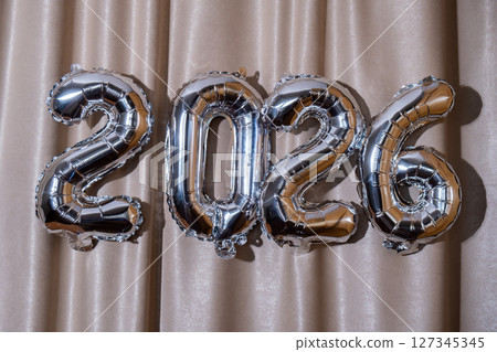 Happy new year 2026 metallic balloons on atlas textile background. Greeting card silver foil balloons numbers Christmas holiday concept. Celebration party congratulation Happy new year 2026 metallic balloons on atlas textile background. Greeting card silver foil balloons numbers Christmas holiday concept. Celebration party congratulation 127345345