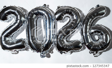 Happy new year 2026 metallic balloons on white background. Greeting card silver foil balloons numbers Christmas holiday concept. Celebration party congratulation 127345347