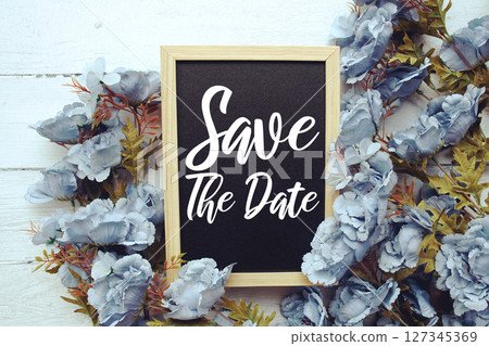 Save the Date typography text with flower decorated on wooden background 127345369
