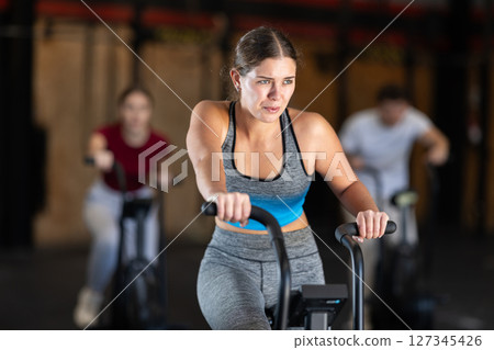 Woman in the top is engaged in an airbike Woman in the top is engaged in an airbike 127345426