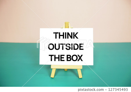 Think outside the box text message on paper card with wooden easel stand Think outside the box text message on paper card with wooden easel stand 127345493