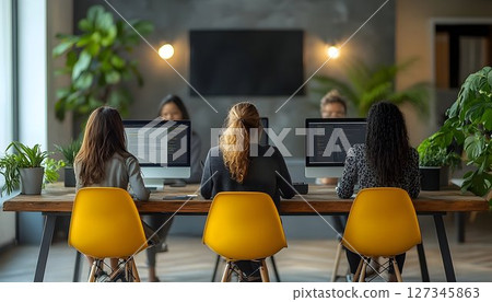 Focused Diverse Women Collaborating on Software Development in Modern Office 127345863