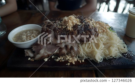 Grilled Pork and Noodles with Peanut Topping on a Wooden Board 127346026