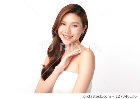 A beautiful young Asian woman with clean, fresh skin against a white background. Skincare, facial treatment, cosmetology, beauty, and spa. An elegant portrait of an Asian woman. 127346170