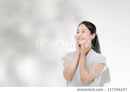 A woman in her twenties doing summer skin care A woman in her twenties doing summer skin care 127346247