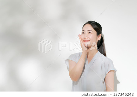 A woman in her twenties doing summer skin care A woman in her twenties doing summer skin care 127346248