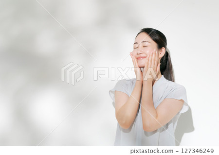 A woman in her twenties doing summer skin care A woman in her twenties doing summer skin care 127346249