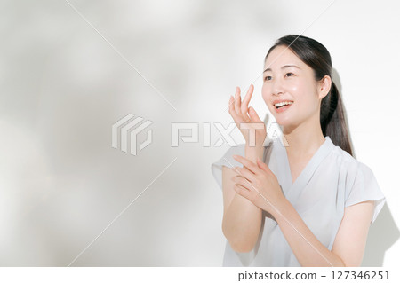 A woman in her twenties doing summer skin care A woman in her twenties doing summer skin care 127346251