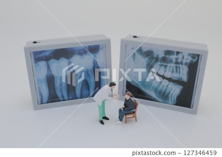 Mini Doctors Analyzing Medical X Rays in Clinical Setting Mini Doctors Analyzing Medical X Rays in Clinical Setting 127346459