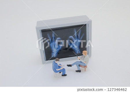 Mini Doctors Analyzing Medical X Rays in Clinical Setting Mini Doctors Analyzing Medical X Rays in Clinical Setting 127346462