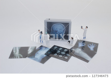 Mini Doctors Analyzing Medical X Rays in Clinical Setting 127346473