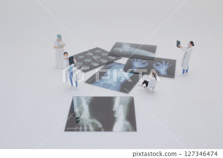 Mini Doctors Analyzing Medical X Rays in Clinical Setting 127346474