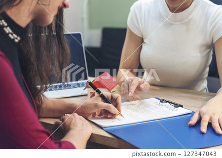 Close up Team Businesswoman hands partners sign contract with success business deal. Diversity Businesswoman teams handshake together. Partnership teamwork meeting signing contract business concept 127347043