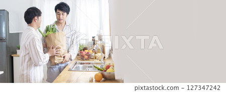 Banner Happy gay couple enjoy breakfast in kitchen drinking coffee. Panorama Two best friends LGBTQ relation partner home cooking. Wide Happiness romance homosexual marriage lifestyle with copy space Banner Happy gay couple enjoy breakfast in kitchen drinking coffee. Panorama Two best friends LGBTQ relation partner home cooking. Wide Happiness romance homosexual marriage lifestyle with copy space 127347242