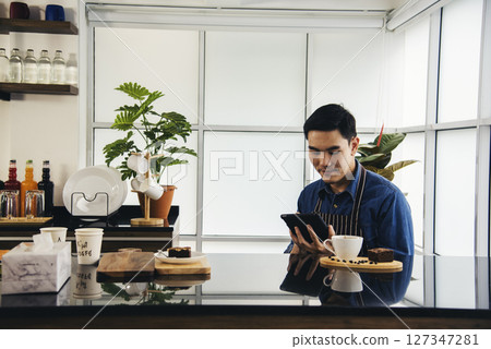 Coffee barista man make espresso shot from coffee maker hot cup. Cappuccino with milk in italian coffee shop cafe. Close up hands of barista use machine make brown latte art for customer cafeteria 127347281