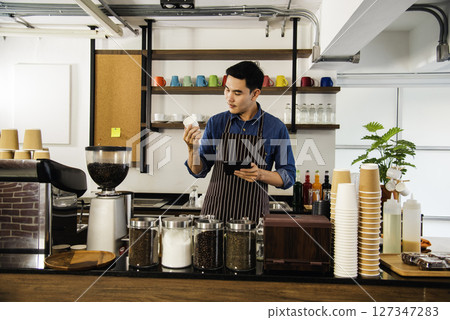 Close up hands coffee barista man make hot cup espresso shot from coffee machine. Cappuccino with milk in italian coffee shop cafe. Close up hands of barista use machine make black drinking hot cup 127347283
