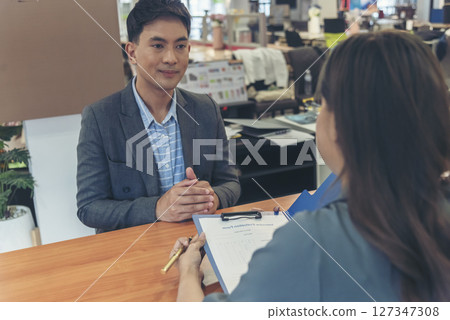 Job HR applicants having an interview with Human resource manager jobs interviewing with confident candidate at business firm office give cv resume. Job Interview with headhunter agent and applicant Job HR applicants having an interview with Human resource manager jobs interviewing with confident candidate at business firm office give cv resume. Job Interview with headhunter agent and applicant 127347308