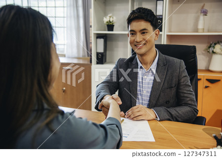 Job HR applicants having an interview with Human resource manager jobs interviewing with confident candidate at business firm office give cv resume. Job Interview with headhunter agent and applicant 127347311