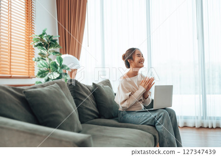 Funny euphoric young asian woman celebrating winning 127347439