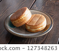 "Oyaki" is a type of baked confectionery. It is a Japanese sweet made of dough wrapped around red bean paste. It is also called obanyaki or imagawayaki. 127348263