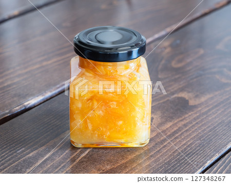 玻璃罐中裝滿了用柑橘皮和水果甜燉製成的果醬。 127348267