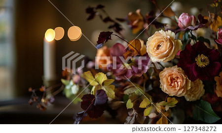 Elegant autumn floral arrangement in warm, muted tones against a bokeh background of golden light. 127348272