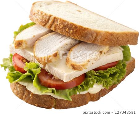 A classic sliced chicken sandwich with fresh lettuce juicy tomato and savory grilled chicken between slices of soft white bread 127348581