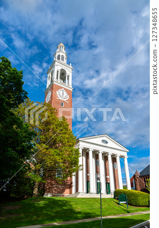 Ira Allen Chapel at the University of Vermont in Burlington, United States, rises with a brick clock tower and columned portico beneath a vivid blue spring sky. Ira Allen Chapel at the University of Vermont in Burlington, United States, rises with a brick clock tower and columned portico beneath a vivid blue spring sky. 127348655