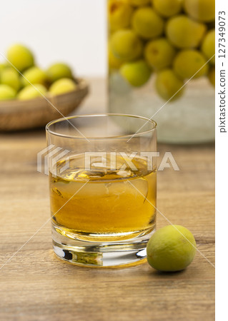 Homemade plum wine and green plums 127349073