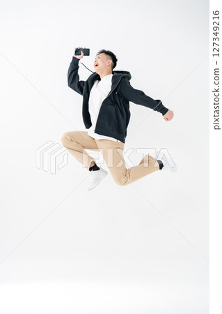 Young man portrait casual jump Young man portrait casual jump 127349216