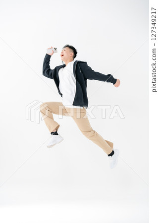 Young man portrait casual jump Young man portrait casual jump 127349217