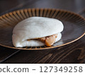 A braised pork bun stuffed with tongporo (braised pork cubes) wrapped in a pao. 127349258