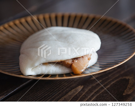 A braised pork bun stuffed with tongporo (braised pork cubes) wrapped in a pao. 127349258