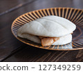 A braised pork bun stuffed with tongporo (braised pork cubes) wrapped in a pao. 127349259