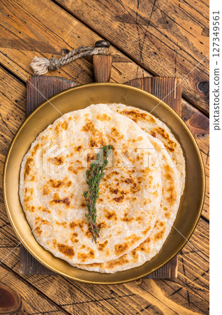 Potato Stuffed Flat Bread Aloo paratha, Traditional Indian food. wooden background. top view Potato Stuffed Flat Bread Aloo paratha, Traditional Indian food. wooden background. top view 127349561