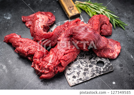 Alternative Beef cut Machete Skirt Steak, raw prime meat on butcher table. black background. top view 127349585