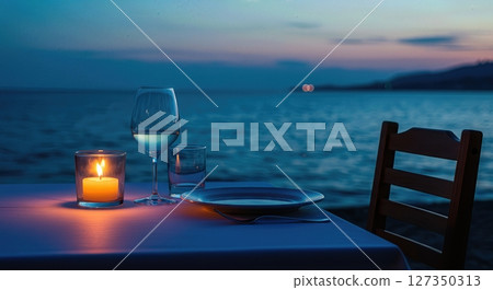 Candlelit Seaside Dinner Table for One at Twilight with Ocean Horizon 127350313