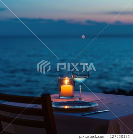 Candlelit Seaside Dinner Table for One at Twilight with Ocean Horizon 127350325
