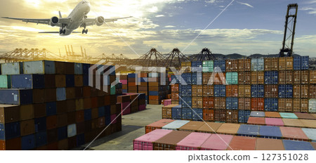 Airplane flying above container logistic. Freight transportation. Logistic industry. Container ship. Export logistics. Container at harbor. Truck transport. Air transport. Multi-modal transportation. 127351028