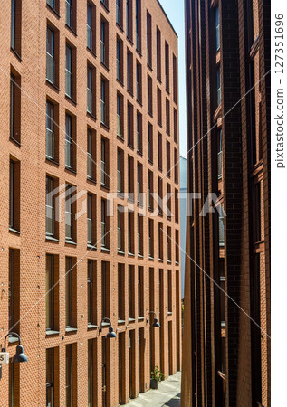 Modern brick apartment buildings with geometric windows in urban cityscape. High quality photo Modern brick apartment buildings with geometric windows in urban cityscape. High quality photo 127351696