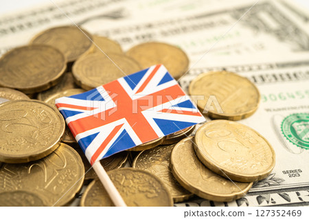 Stack of coins with United Kingdom UK flag and US dollar banknotes. 127352469