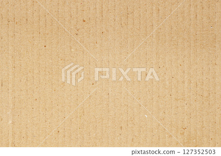 Natural cardboard surface texture with recycled fibers and subtle vertical lines. Warm beige background for eco designs and mockups. Concept of paper material 127352503