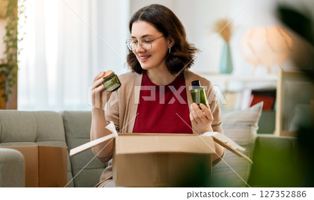 Woman is unpacking cardboard 127352886