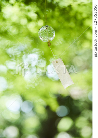 Wind chimes swaying in the wind under the summer sunlight 127353050
